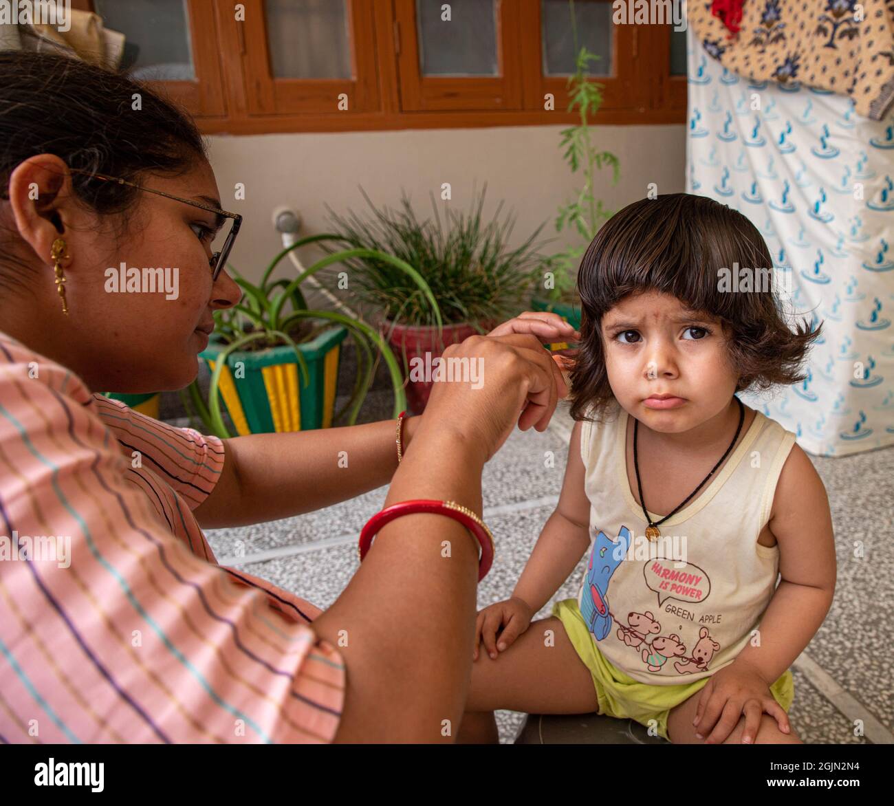 portrait of cute indian baby girl during haircut Stock Photo - Alamy