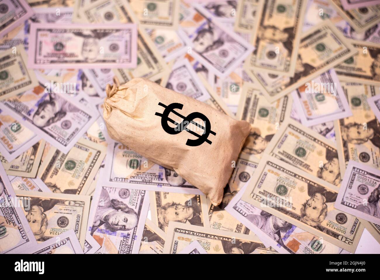 A stag of US paper currency in us dollar sign bag on US paper currency background. Stock Photo