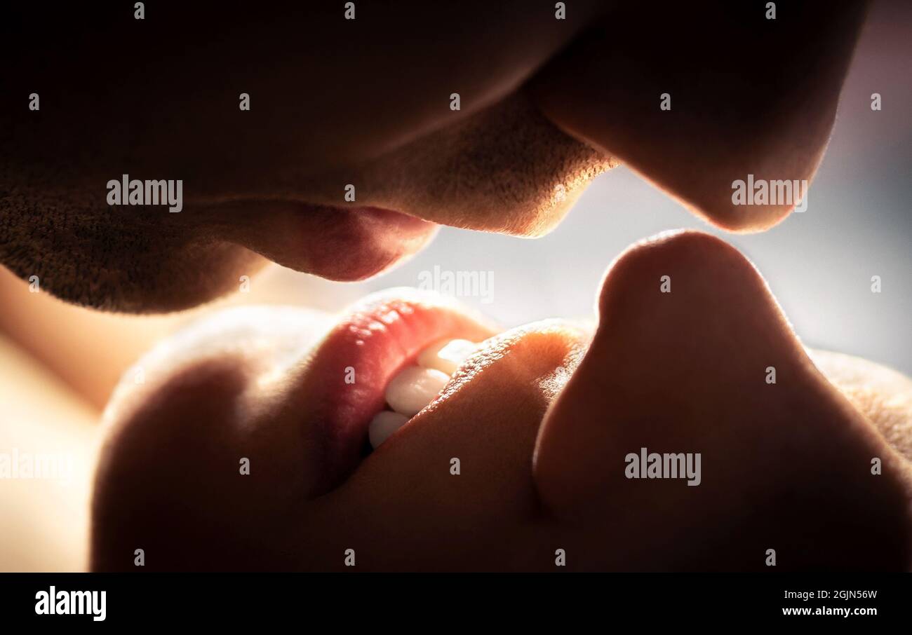 Couple kissing. Close up of lips. Man and woman having sex. Romantic love, passionate temptation and chemistry. Foreplay, intimacy. Stock Photo