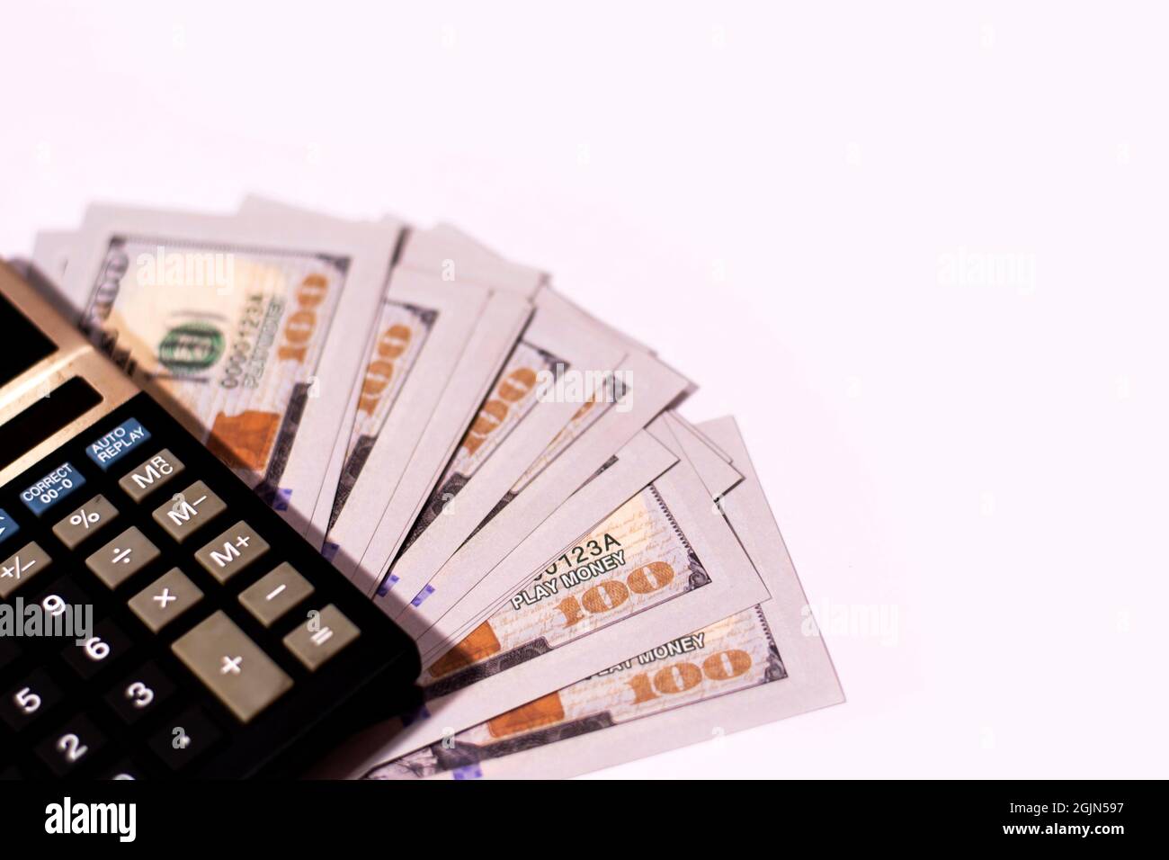 Counting US paper currency one hundred dollar in a calculator on