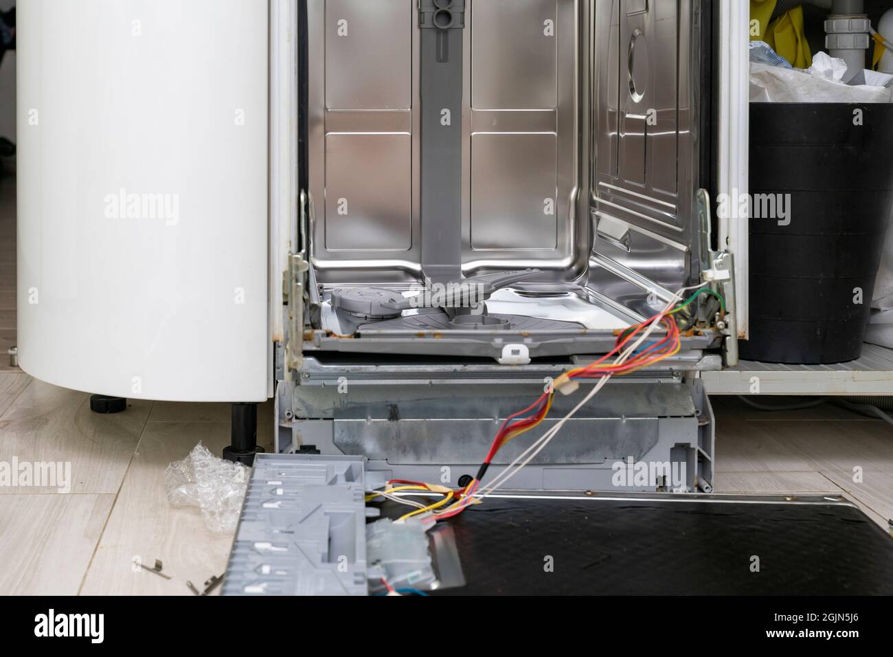 fixing a home dishwasher. device door removed for repair Stock Photo