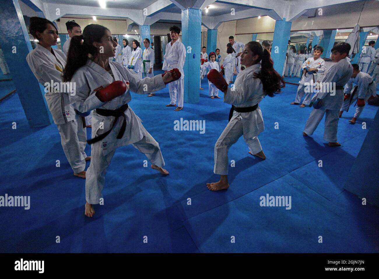 Menaa Asadi (C) during trains children and young people at a karate ...