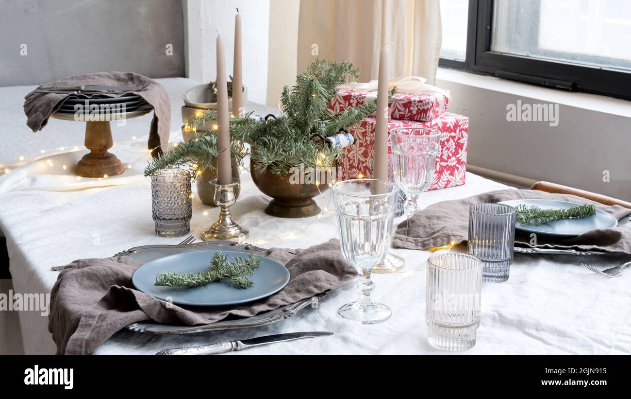 Christmas table setting for a festive dinner. Dinnerware, candles and ...