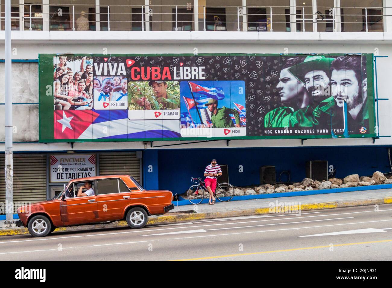 HAVANA, CUBA - FEB 21, 2016: Soviet Lada car and a propagandistic poster in Vedado neighborhood of Havana. Stock Photo