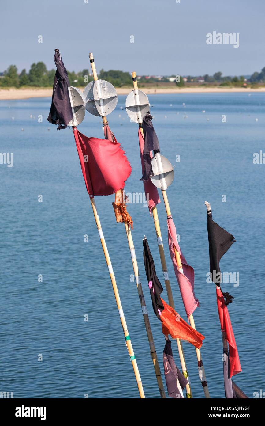 Black and red flags of fishing nets in Mechelinki small fishing port, Poland Stock Photo