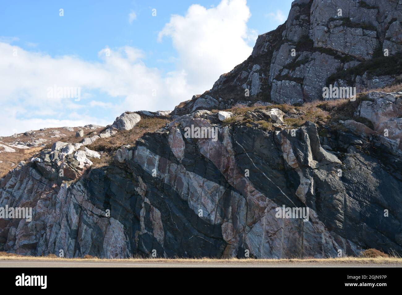 Colourful Rockface made up of a mix of dolerite, gneiss and granite Stock Photo