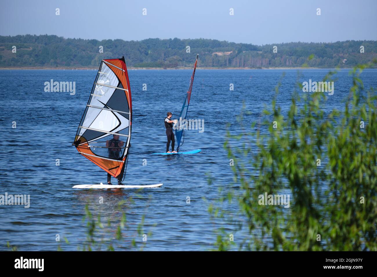 Two surfers learn to swim, Pucka Bay, Baltic, Poland Stock Photo
