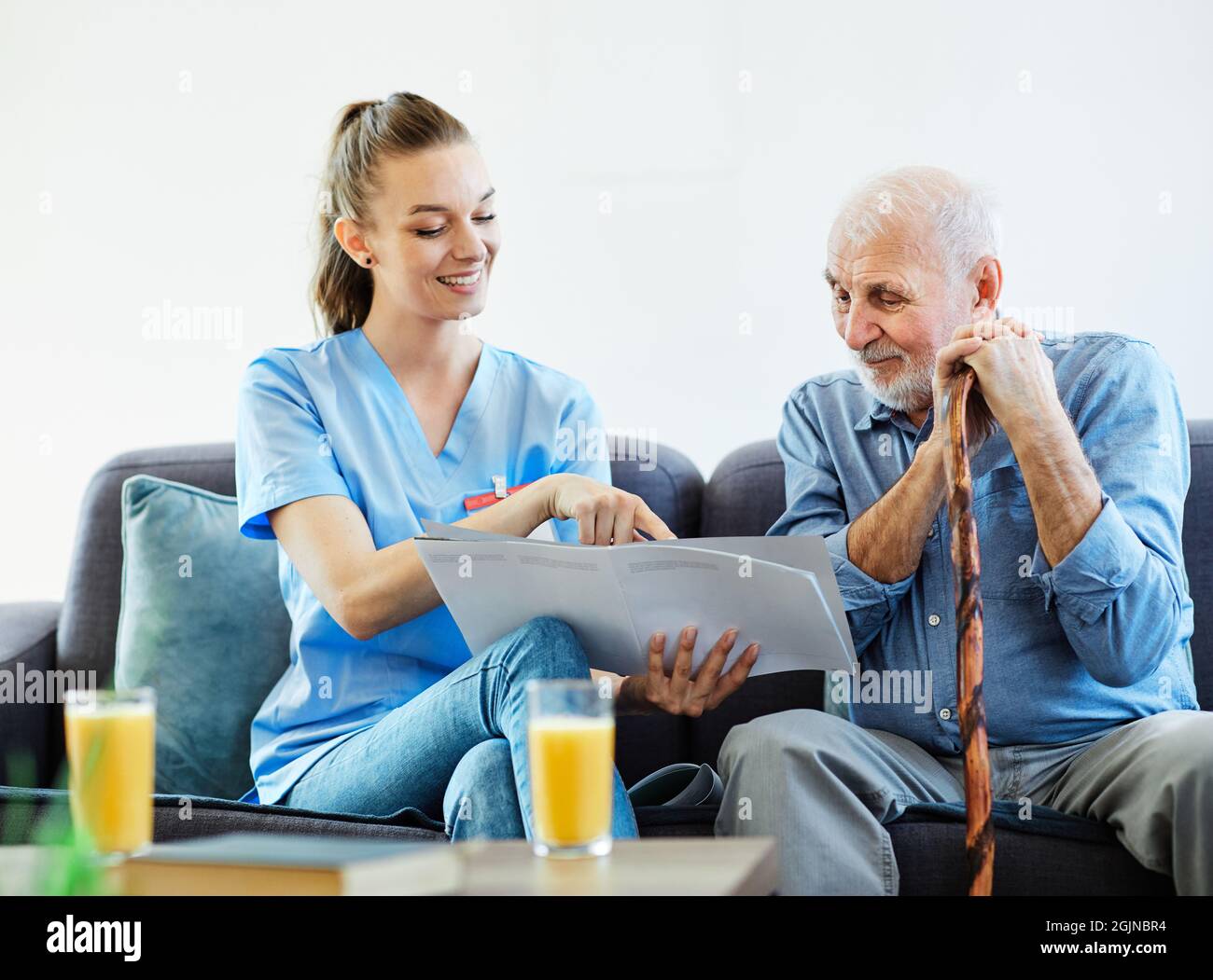 nurse doctor senior care brochure showing caregiver help assistence retirement home nursing elderly man Stock Photo