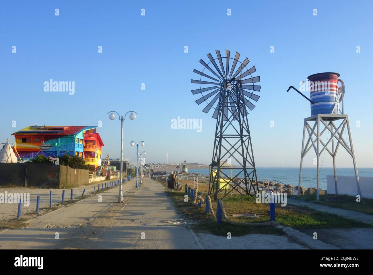 Empty footway in Vama Veche nonconformist resort on the Black Sea shore in Romania in early morning at the end of the summer season Stock Photo