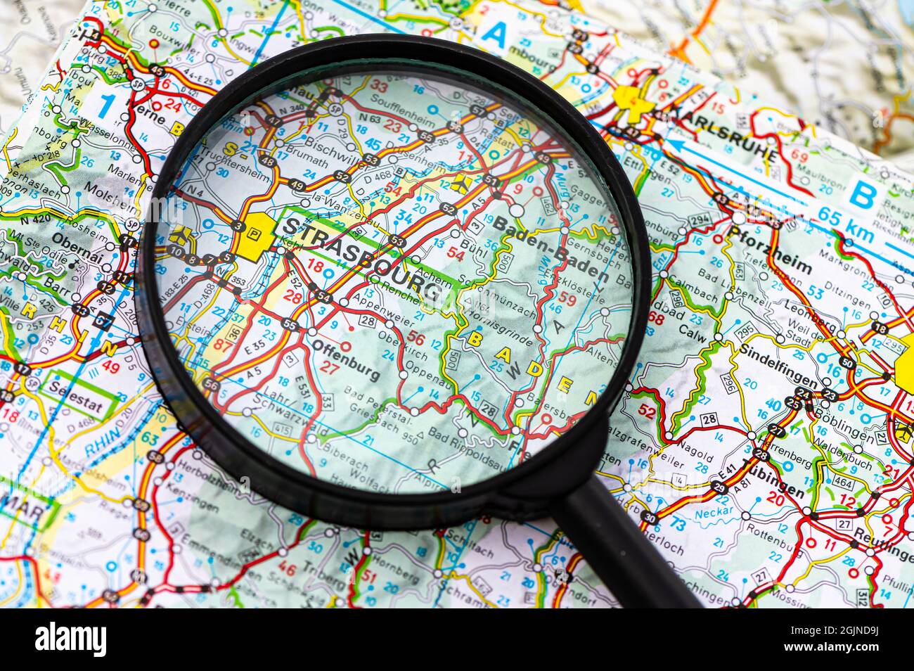 地図・旅行ガイド Vision and Comprehension of Strasbourg map of Strasbourg in France through magnifying glass, concept of