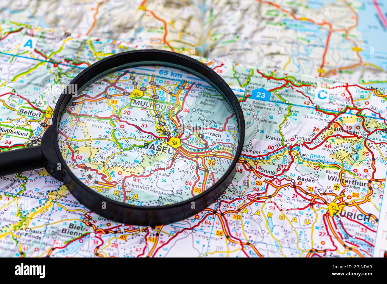 map of Basel in Switzerland through magnifying glass, concept of planning the travel itinerary Stock Photo