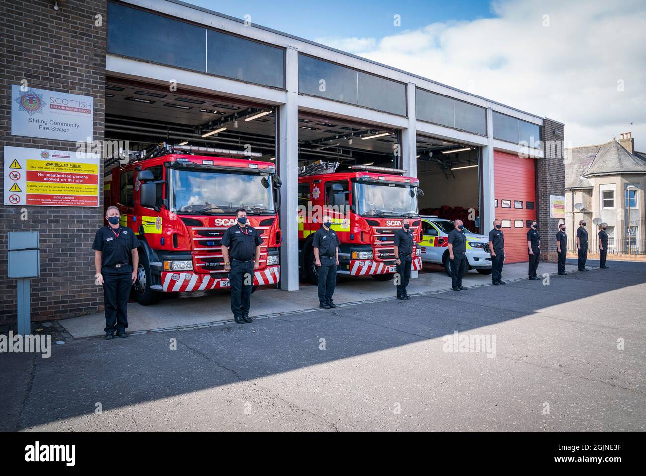 Fire fighters outside Stirling Community Fire Station, Stirling, holding a minute's silence, to mark the 20th anniversary of the September 11 terrorist attack by al Qaida in the United States. Picture date: Saturday September 11, 2021. Stock Photo