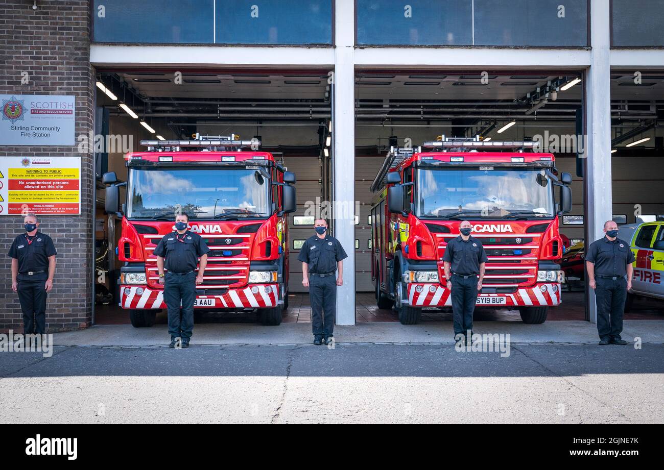 Fire fighters outside Stirling Community Fire Station, Stirling, holding a minute's silence, to mark the 20th anniversary of the September 11 terrorist attack by al Qaida in the United States. Picture date: Saturday September 11, 2021. Stock Photo