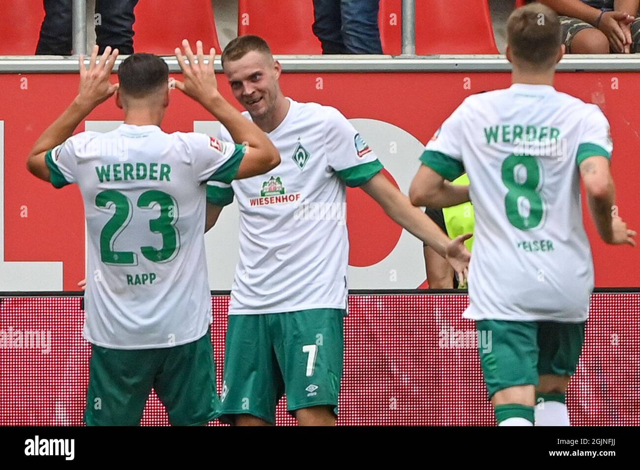 Ingolstadt, Germany. 11th Sep, 2021. Football: 2. Bundesliga, FC Ingolstadt 04 - Werder Bremen, Matchday 6, Audi Sportpark. Bremen's Marvin Ducksch (centre) celebrates with his team-mates Nicolai Rapp and Bremen's Mitchell Weiser after scoring the 0:3 against Ingolstadt. Credit: Armin Weigel/dpa - IMPORTANT NOTE: In accordance with the regulations of the DFL Deutsche Fußball Liga and/or the DFB Deutscher Fußball-Bund, it is prohibited to use or have used photographs taken in the stadium and/or of the match in the form of sequence pictures and/or video-like photo series./dpa/Alamy Live News Stock Photo