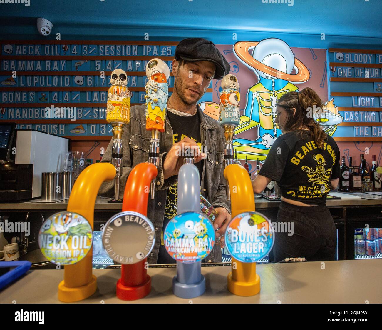 Barman pulling pint of beer into glass at The Corner Pin pub in Tottenham, United Kingdom Stock Photo