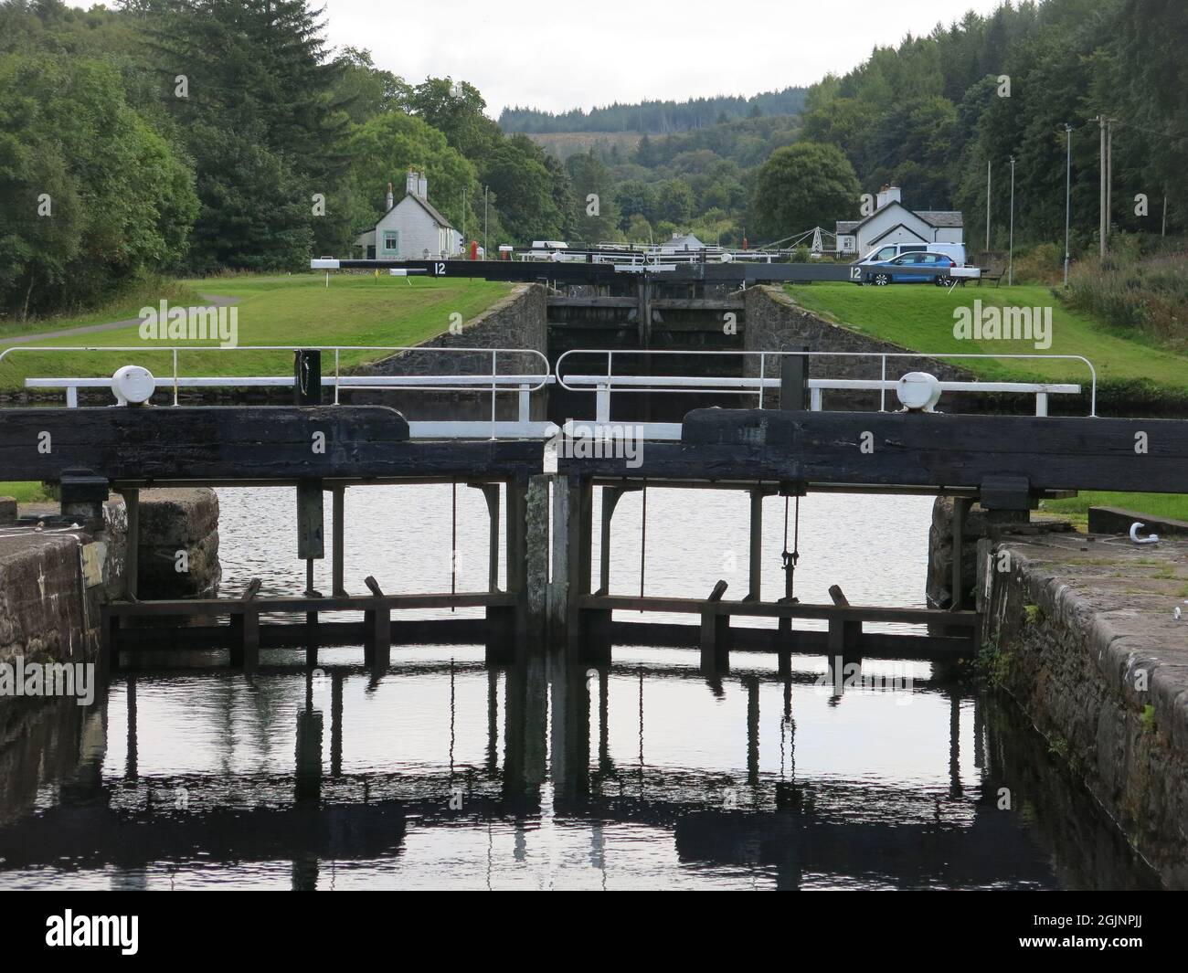 View of the flight of lock gates at Dunardry on the Crinan Canal, which provides a navigable waterway across the Kintyre Peninsula to the west coast. Stock Photo
