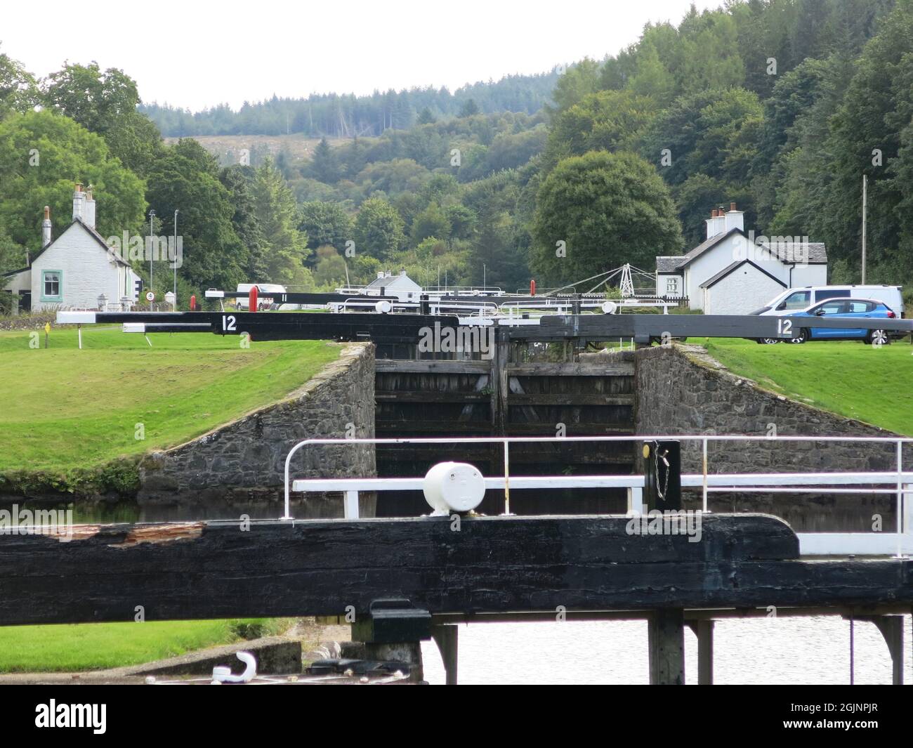 View of the flight of lock gates at Dunardry on the Crinan Canal, which provides a navigable waterway across the Kintyre Peninsula to the west coast. Stock Photo