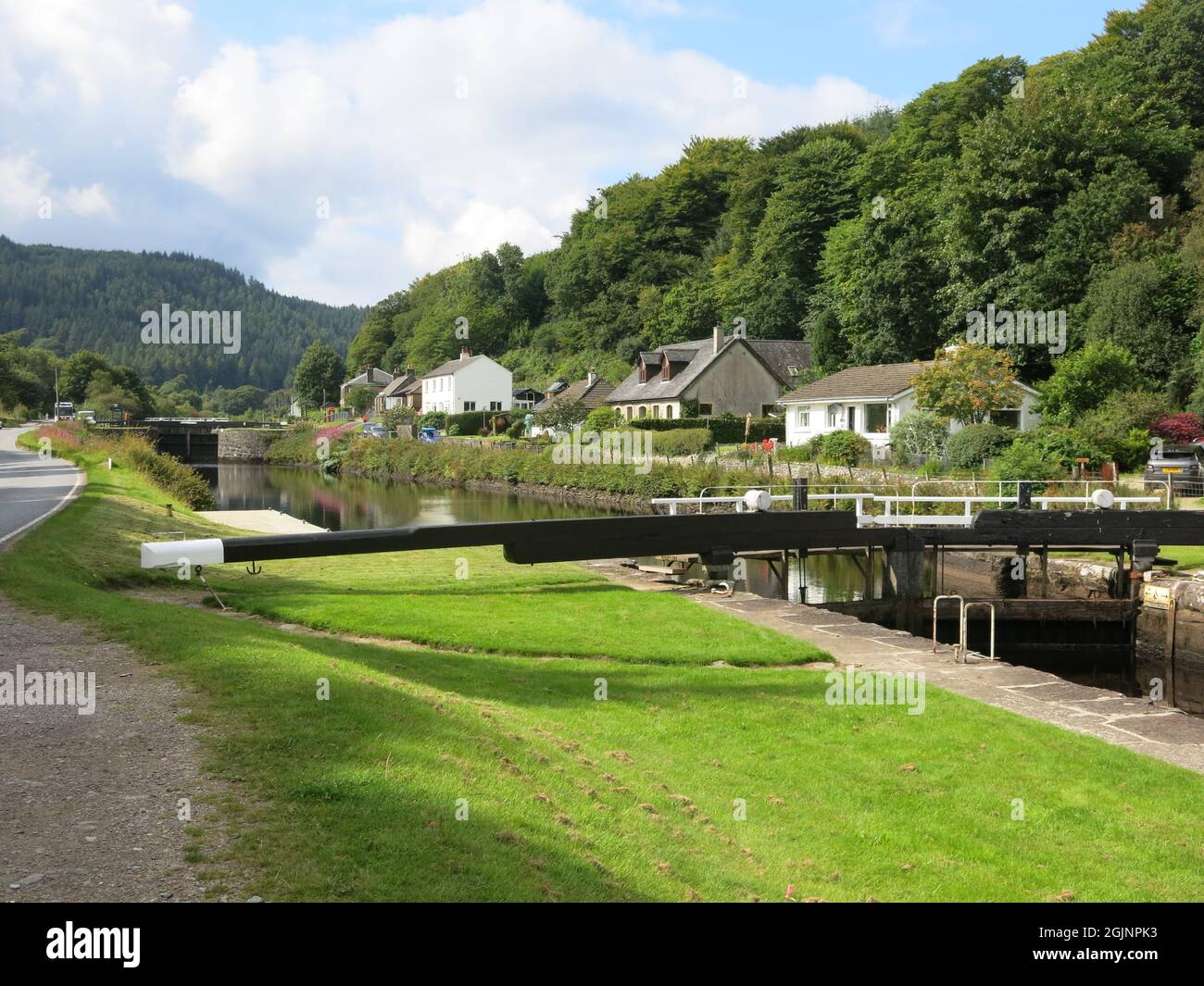 View along the Crinan Canal from one of the lock gates at Dunardry with the splendid Scottish scenery of trees & mountains. Stock Photo