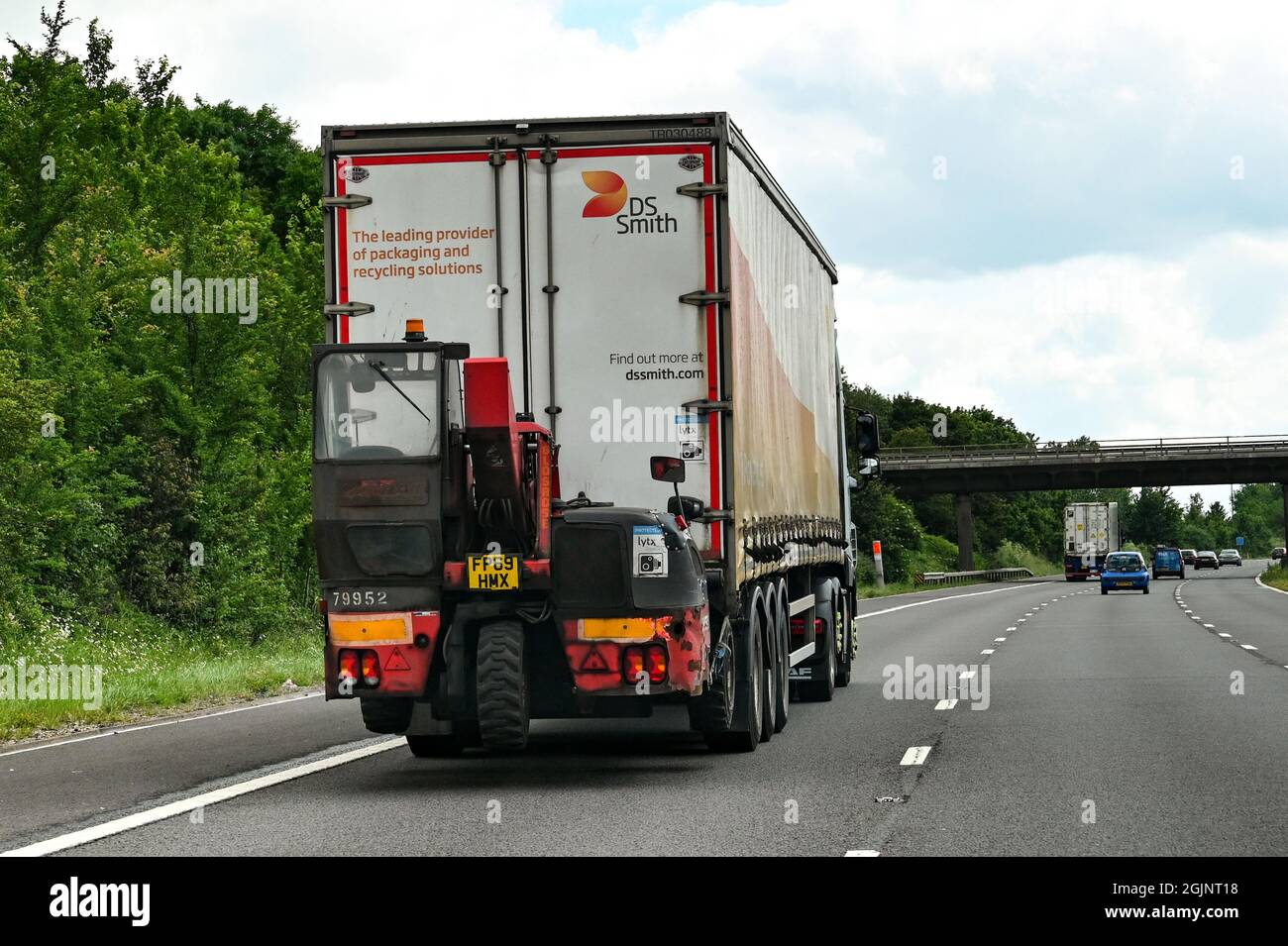 Swindon, England - June 2021: Articulated lorry carrying its own fork lift truck for unloading Stock Photo
