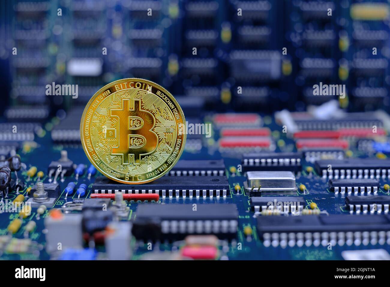 Golden bitcoin cryptocurrency new version on computer electronic circuit board background Stock Photo
