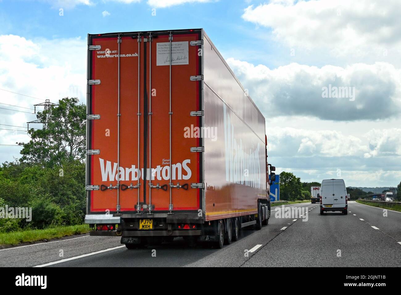 Swindon, England - June 2021: Tall box sided articulated lorry operated by bread manufacturer Warburtons driving on the M4 motorway Stock Photo