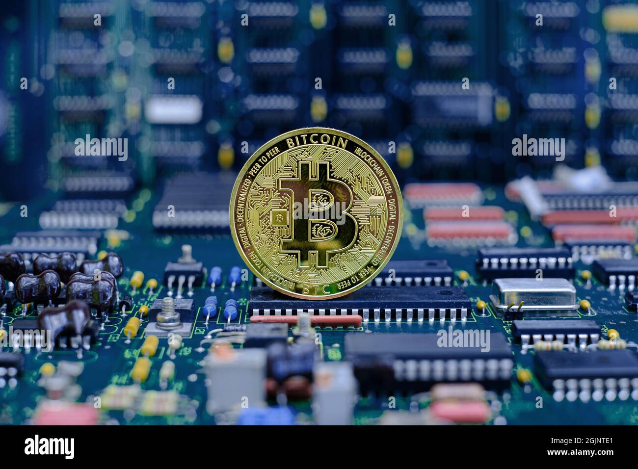 Golden bitcoin cryptocurrency new version on computer electronic circuit board background Stock Photo