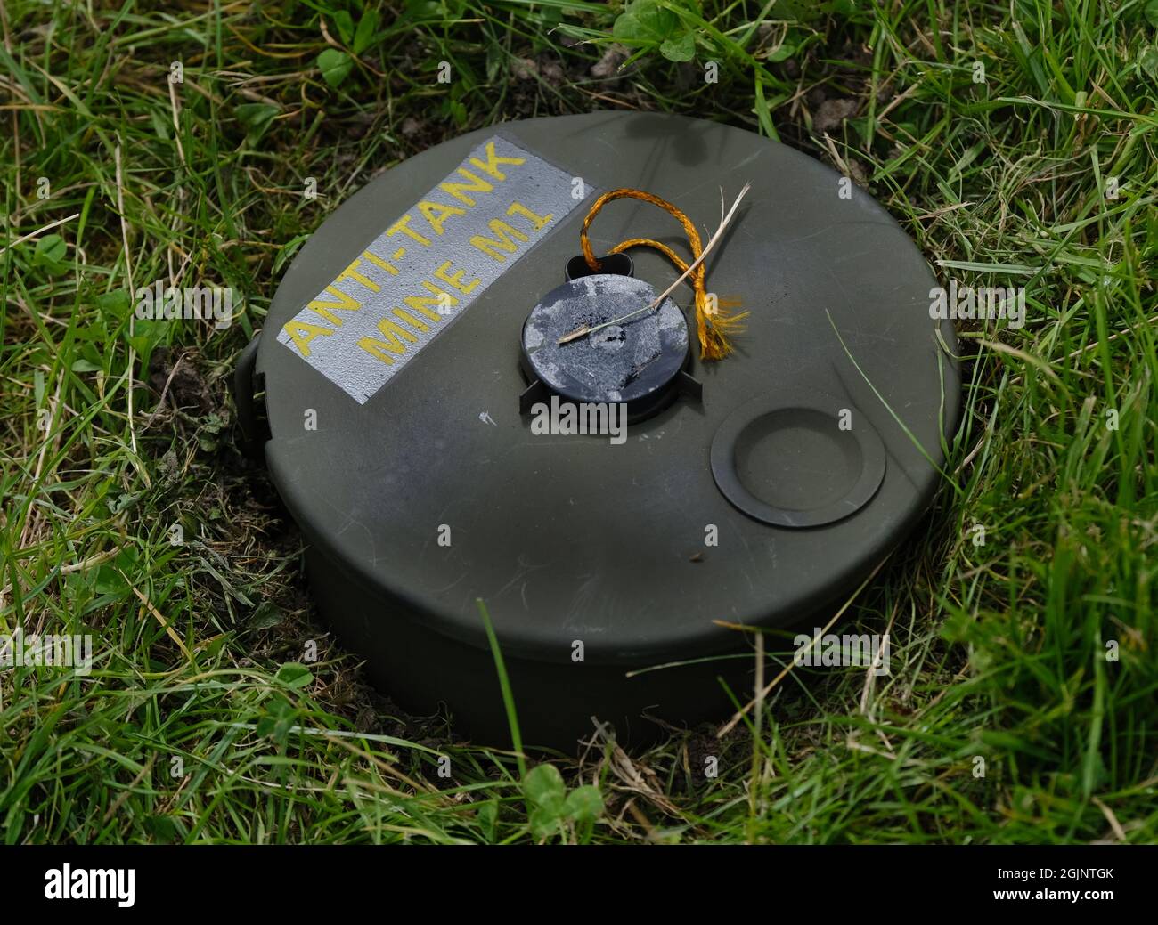 An anti-tank mine (abbreviated to 'AT mine') is a type of land mine designed to damage or destroy vehicles including tanks and armored fighting vehicl Stock Photo