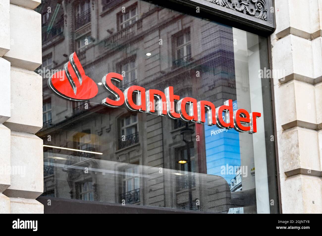 London, England - August 2021: Sign above the entrance to a branch of Santander Bank. Stock Photo