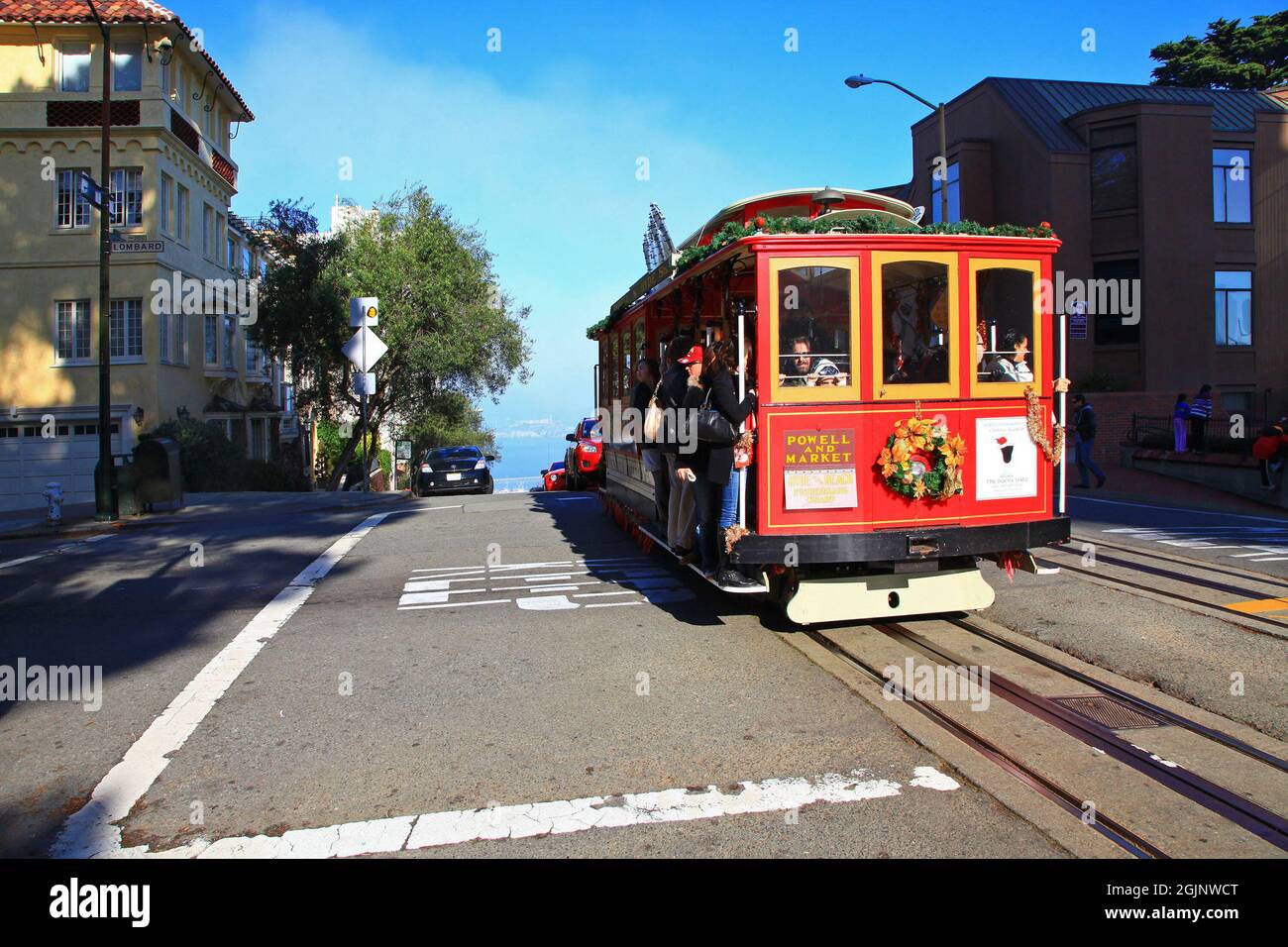 Antique Cable Car Powell Hyde Line on Hyde Street at Lombard Street with Alcatraz Island at the