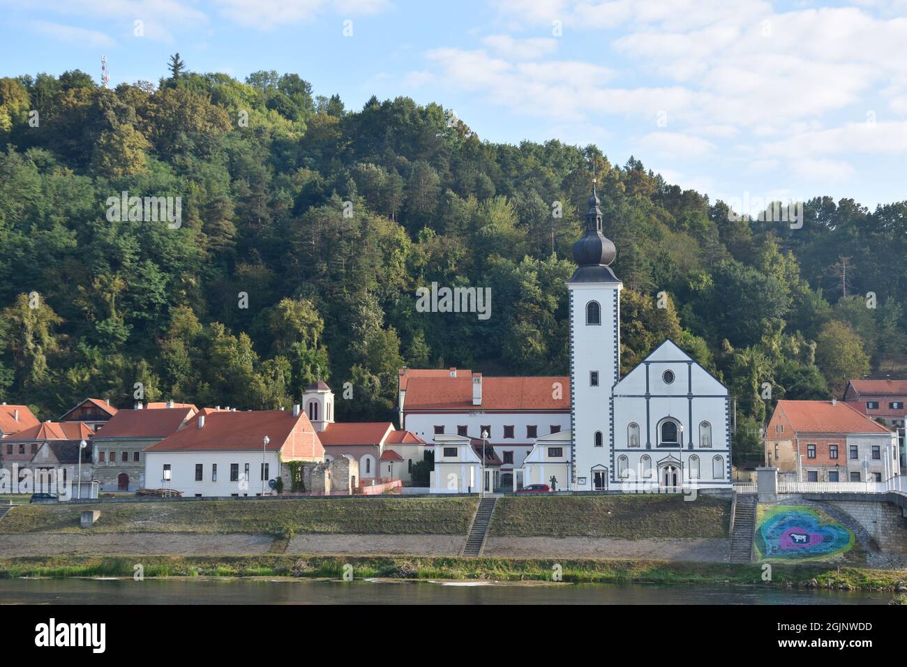 Hrvatska Kostajnica in Croatia, border town with Bosnia, Una river; catholic and orthodox churches side by side Stock Photo