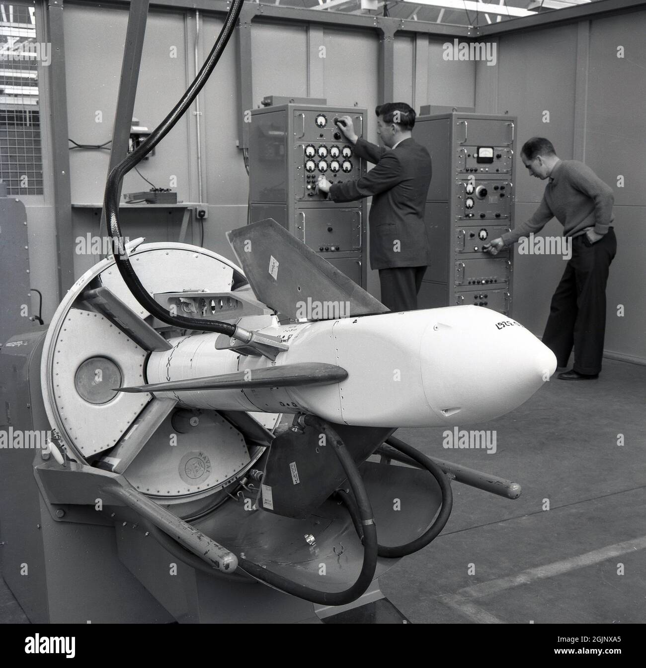 1950s, historical, aircraft technicans using oscillator machines to gather information from electrical tests being carried out on a scaled mechanical aircraft prototype, Short Bros, Rochester, England, UK. Stock Photo
