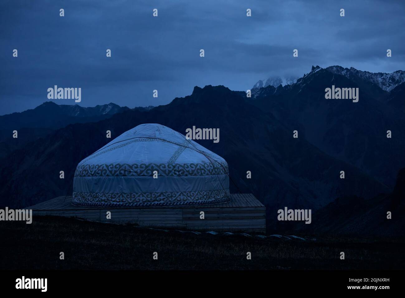 Beautiful scenery Hotel resort with yurt house at Shymbulak at night against snow mountains in Almaty, Kazakhstan. Stock Photo