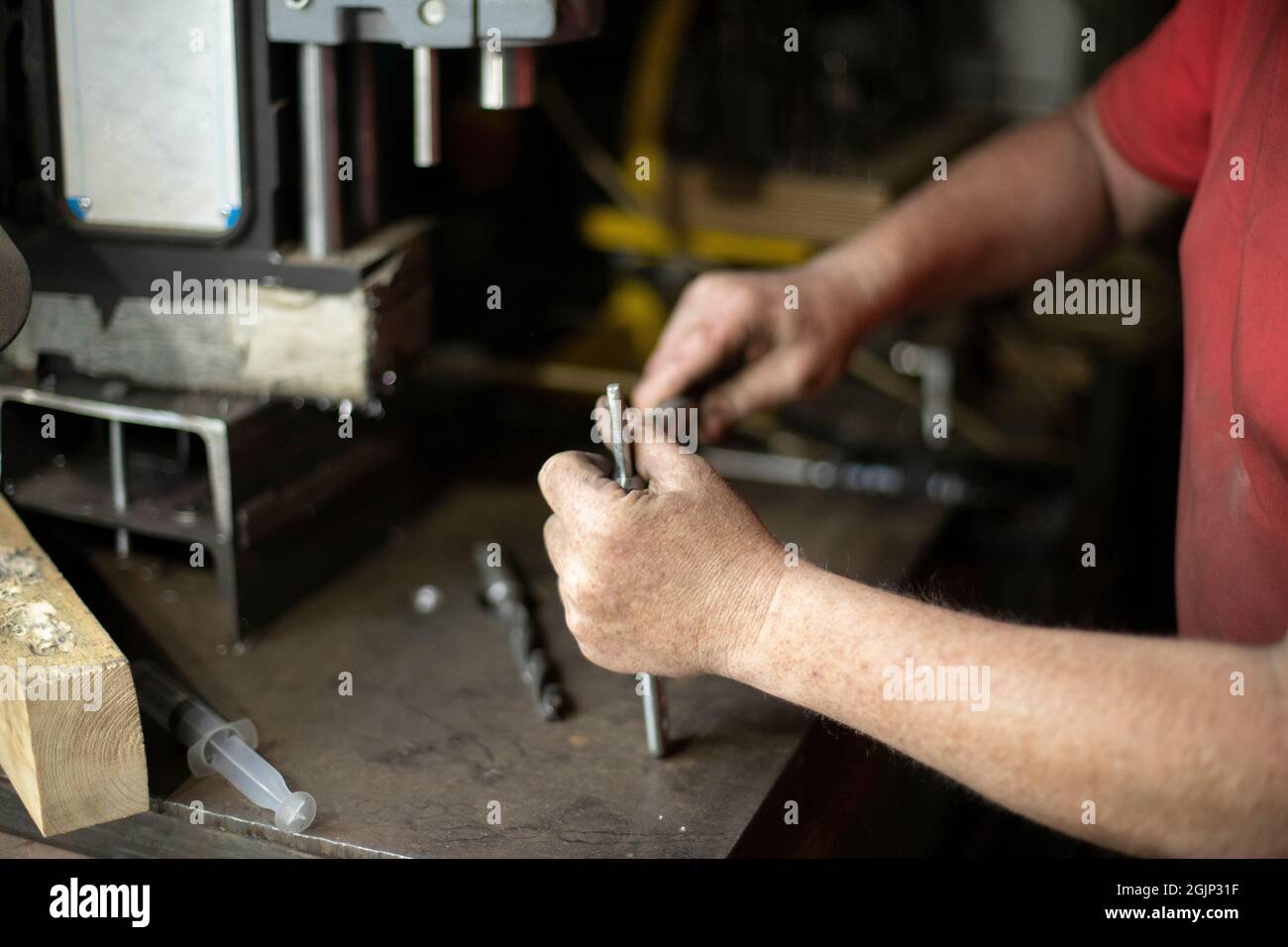 A man pulls out a drill. Installing a drill for a drill. Works in the