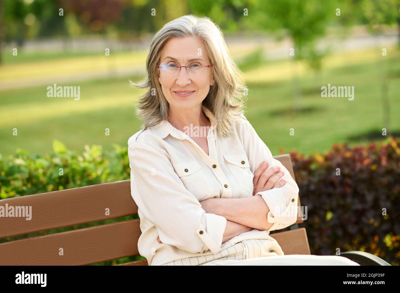 Pretty woman with glasses looking smiling Stock Photo