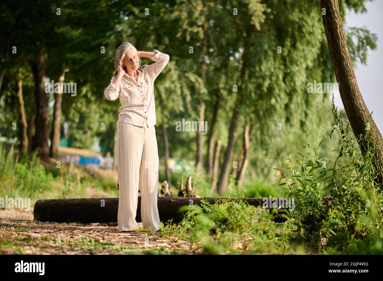 Woman having rest in nature on sunny day Stock Photo
