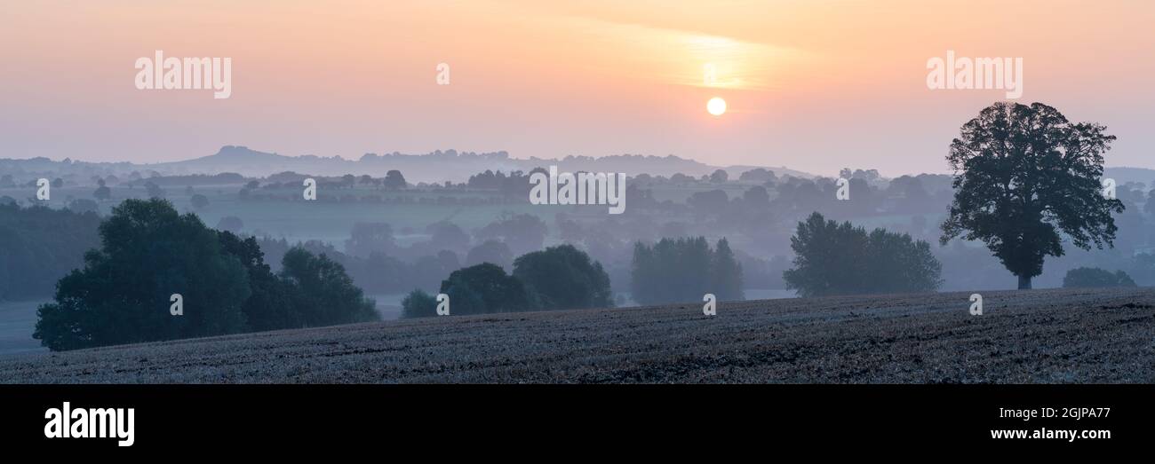 A panoramic image looking over Farnely Park and Lower Wharfedale on a hazy late summer morning, with Almscliffe Crag prominent in the scene. Stock Photo