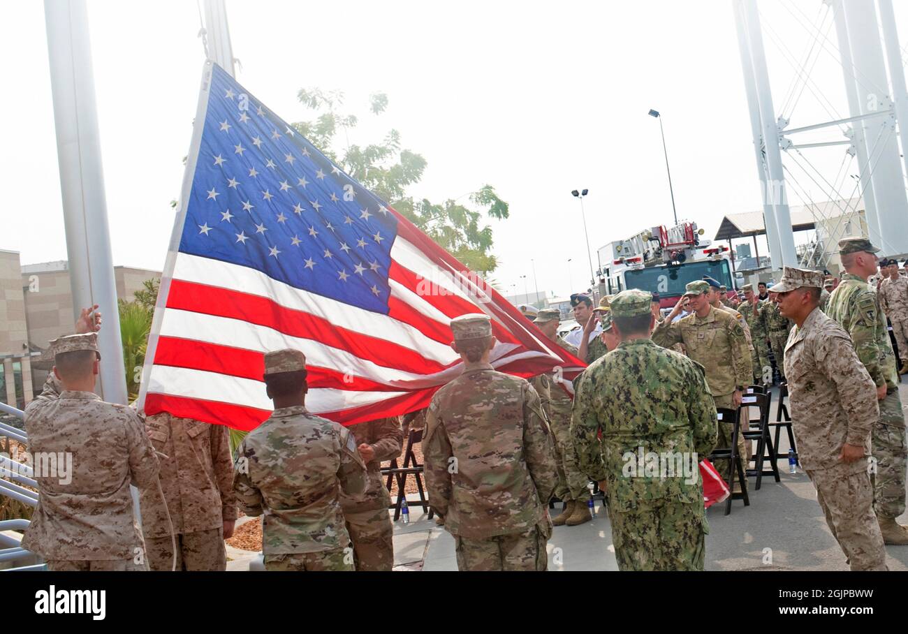 Ambouli, Djibouti. 11th Sep, 2021. U.S. and coalition military service members raise an American flag during a remembrance event on the 20th anniversary of the 9/11 terrorist attacks at Camp Lemonnier September 11, 2021 in Ambouli, Djibouti. The event commemorates the nearly 3,000 people killed by terrorists on September 11th, 2001. Credit: MC1 Jacob Sippel/U.S. Navy/Alamy Live News Stock Photo