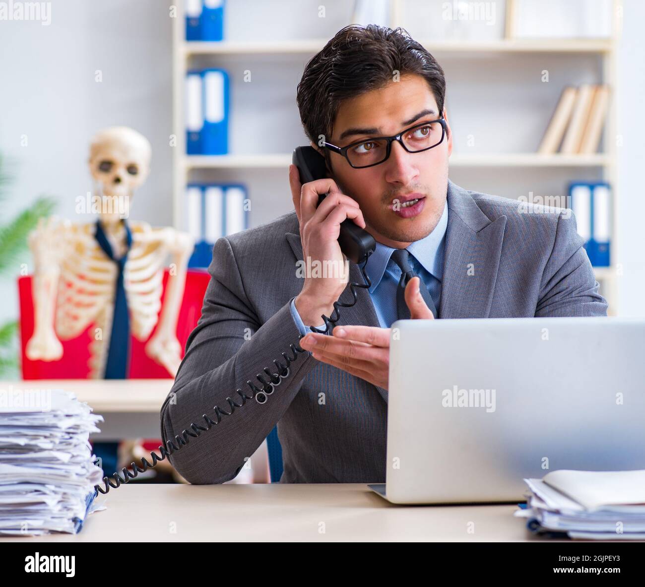 The businessman working with skeleton in office Stock Photo