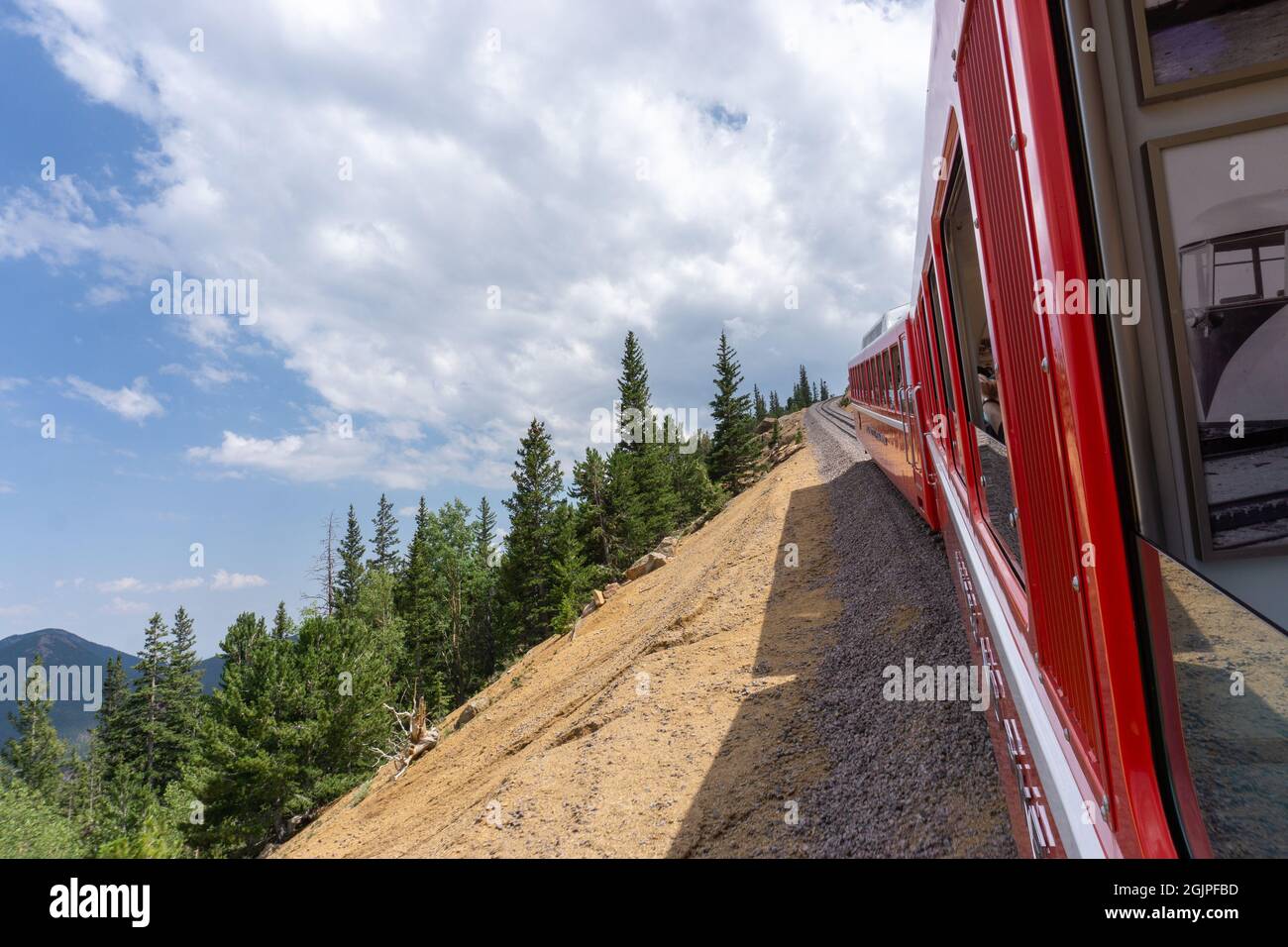 Colorado cog train climbing steep mountain hill up to pikes peak Stock Photo