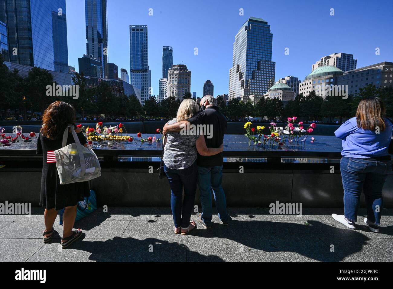 New York, United States. 11th Sep, 2021. People view the memorial at a ceremony at Ground Zero held in commemoration of the 20th anniversary of the terrorist attacks on the World Trade Center, the Pentagon and the crash of United Airlines Flight 93 in Shanksville, PA, held in lower Manhattan, New York City, on Saturday, September 11, 2021. Pool photo by Anthony Behar/UPI Credit: UPI/Alamy Live News Stock Photo