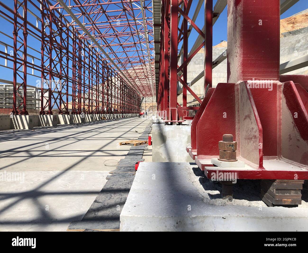 Metal pillar fastened to basement with anchor bolts and nuts Stock