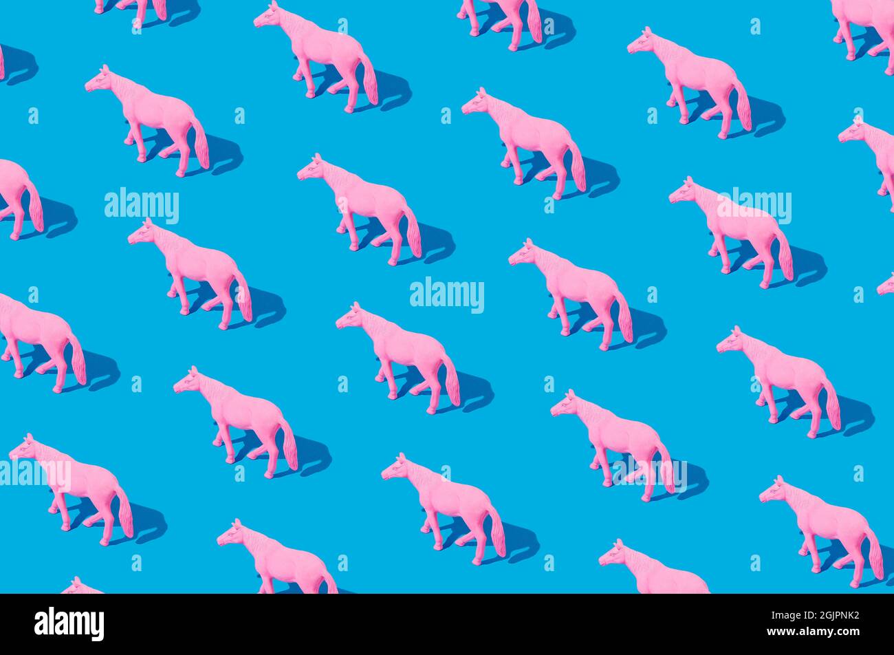 Collage of pink rubber horses isolated on blue background. Isometric ...