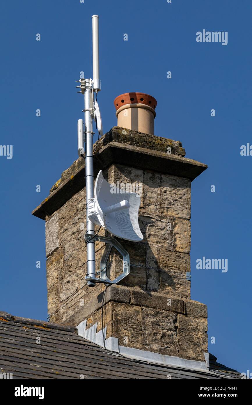 High speed wireless internet receive and transmit mast on a domestic property. United Kingdom. Stock Photo