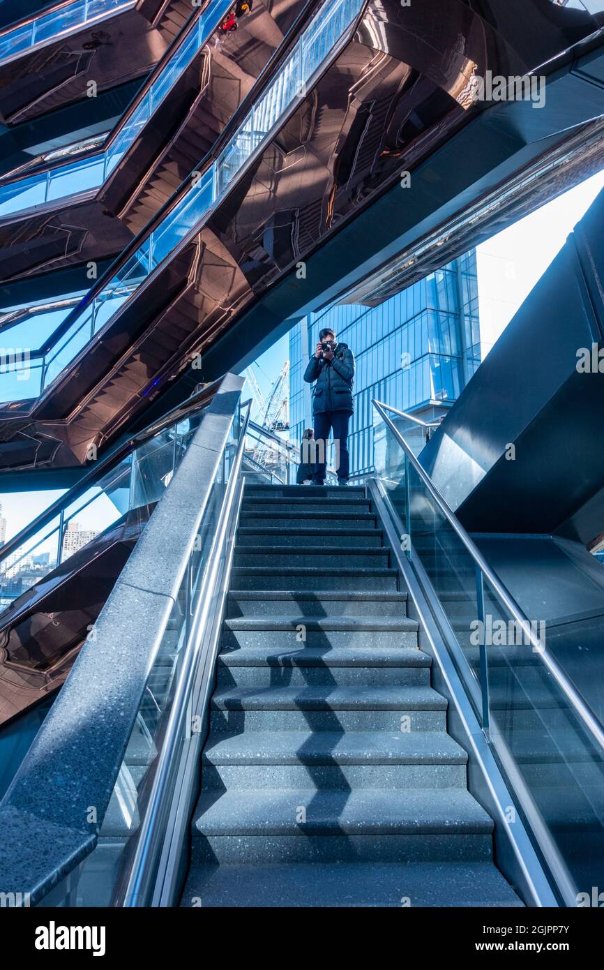 Tourist taking a photo at The Vessel, New York. After the latest incidents, the future of this tourist attraction is uncertain Stock Photo