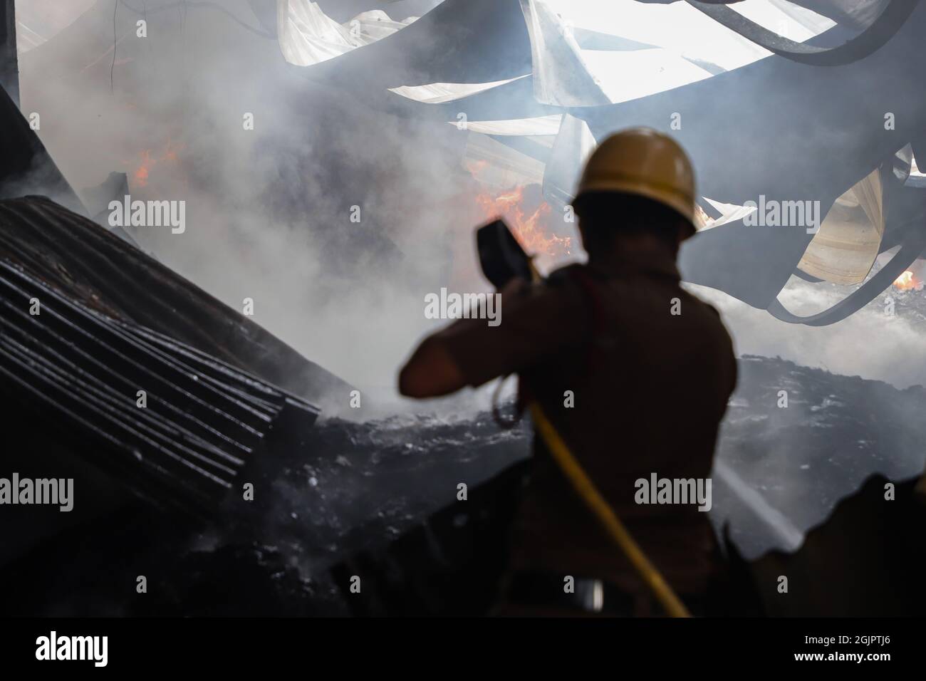 Kolkata, India. 11th Sep, 2021. A firefighter seen working hard to extinguish the fire inside a