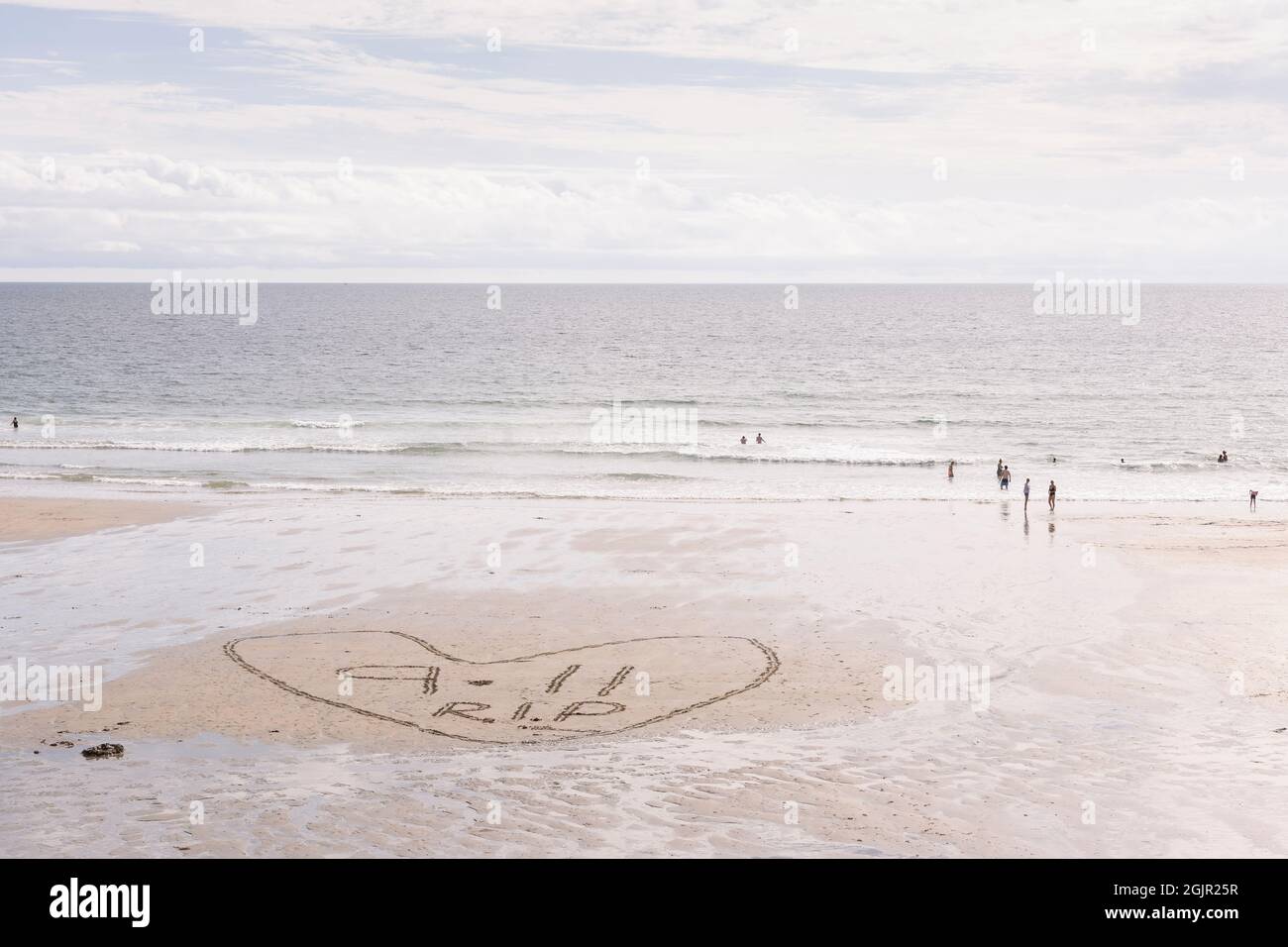 Message in the sand on Perranuthnoe Beach near Penzance, Cornwall to commemorate the 20th anniversary of the tragic 9-11 terrorist attacks on America. Stock Photo