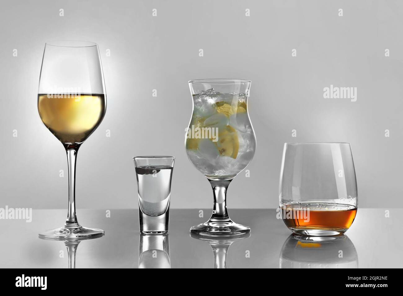 Glasses of wine and spirits on light background Stock Photo Alamy
