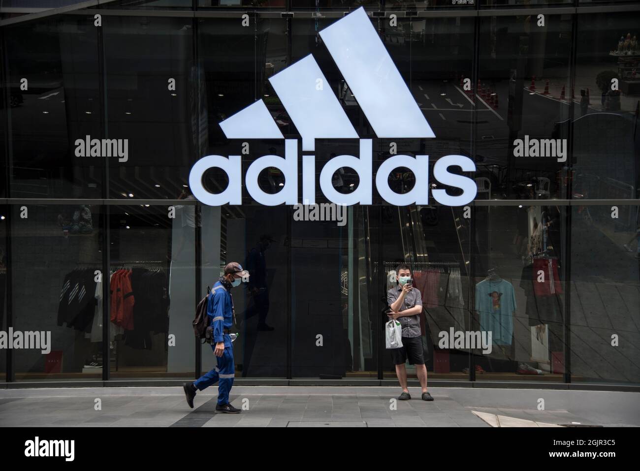 Bangkok, Thailand. 11th Sep, 2021. A man wearing face mask as a preventive  measure against the spread of covid-19 walks past an ADIDAS Shop in Siam  Square. (Photo by Peerapon Boonyakiat/SOPA Images/Sipa