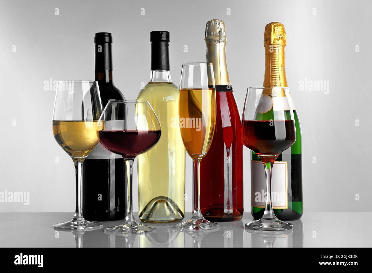 Glasses of wine and spirits on light background Stock Photo Alamy