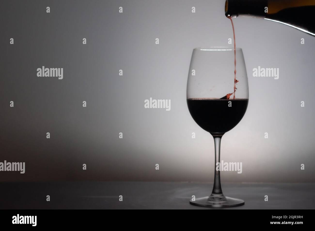 Closeup shot of pouring wine in the glass Stock Photo - Alamy